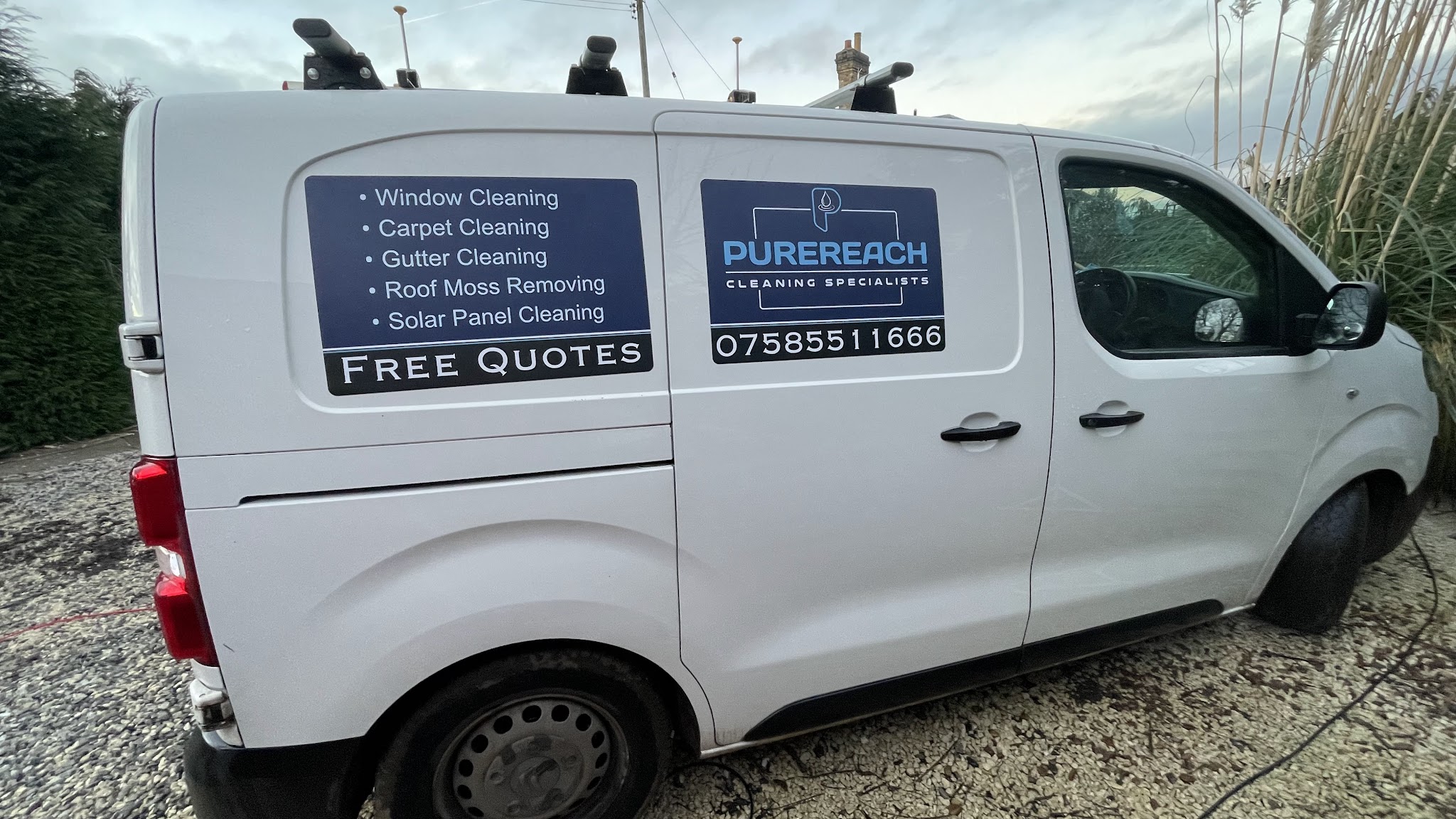 The white Purereach van with its service list, logo and phone number on the side